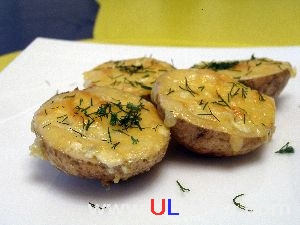 Vegetable Dishes. Potato halves with cheese.
