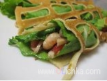Dishes with Seafood. Lacy crepes with shrimp and squid.