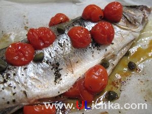 Fish. Sea bass with cherry tomatoes and capers.